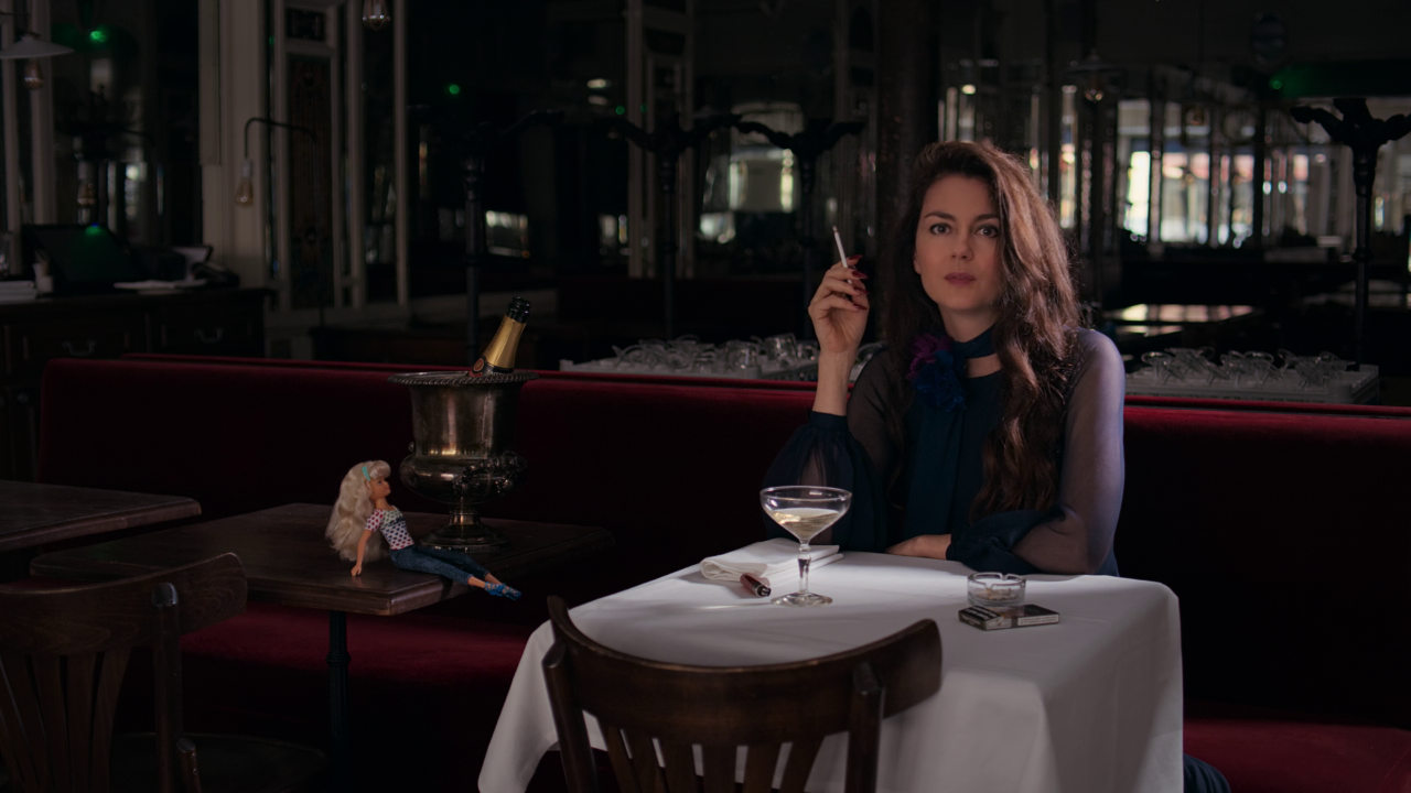 A woman seated at a restaurant table in Coma.